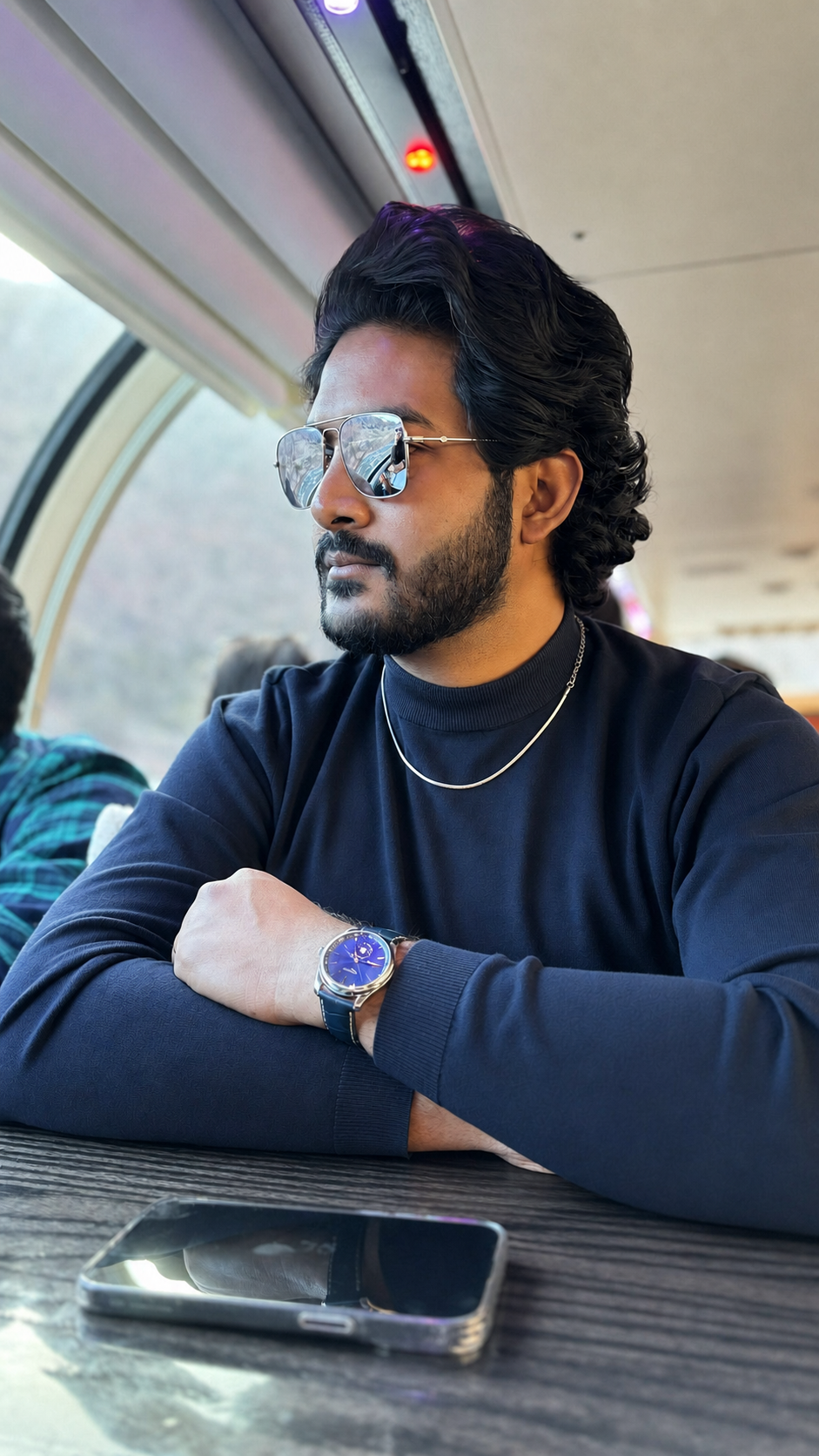 Teja Padala, host of Profoundly, seated by a train window